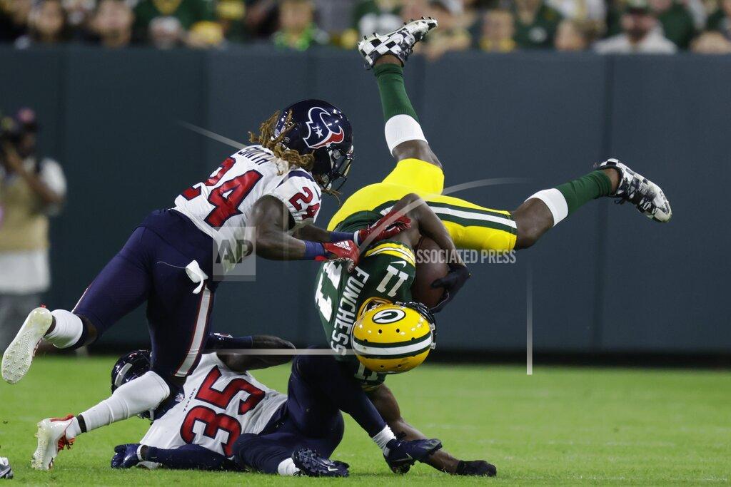 Matt Ludtke Houston Texans' Keion Crossen and Tremon Smith stop Green Bay Packers' Devin Funchess after a catch during the second half of a preseason NFL football game Saturday, Aug. 14, 2021, in Green Bay, Wis. (AP Photo/Matt Ludtke)