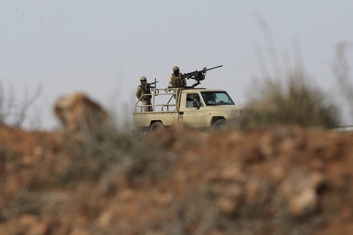 FILE - Jordanian soldiers patrol near the eastern Jordan-Syria border, in al-Washash, Mafraq governorate, Jordan, on Feb. 17, 2022, during media tour organised by the Jordanian army. An airstrike on southern Syria early Thursday Jan. 18, 2024 killed at least nine people and was probably carried out by Jordan's air force, Syrian opposition activists said, the latest in a series of strikes in an area where cross-border drug smugglers have been active. (AP Photo/Raad Adayleh, File)