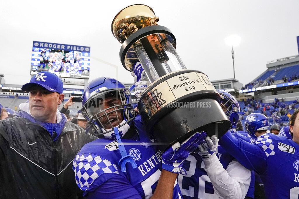 Bryan Woolston Kentucky players hoist The Governor's Cup after defeating Louisville in the NCAA college football game, Saturday, Nov. 30, 2019, in Lexington, Ky. (AP Photo/Bryan Woolston)