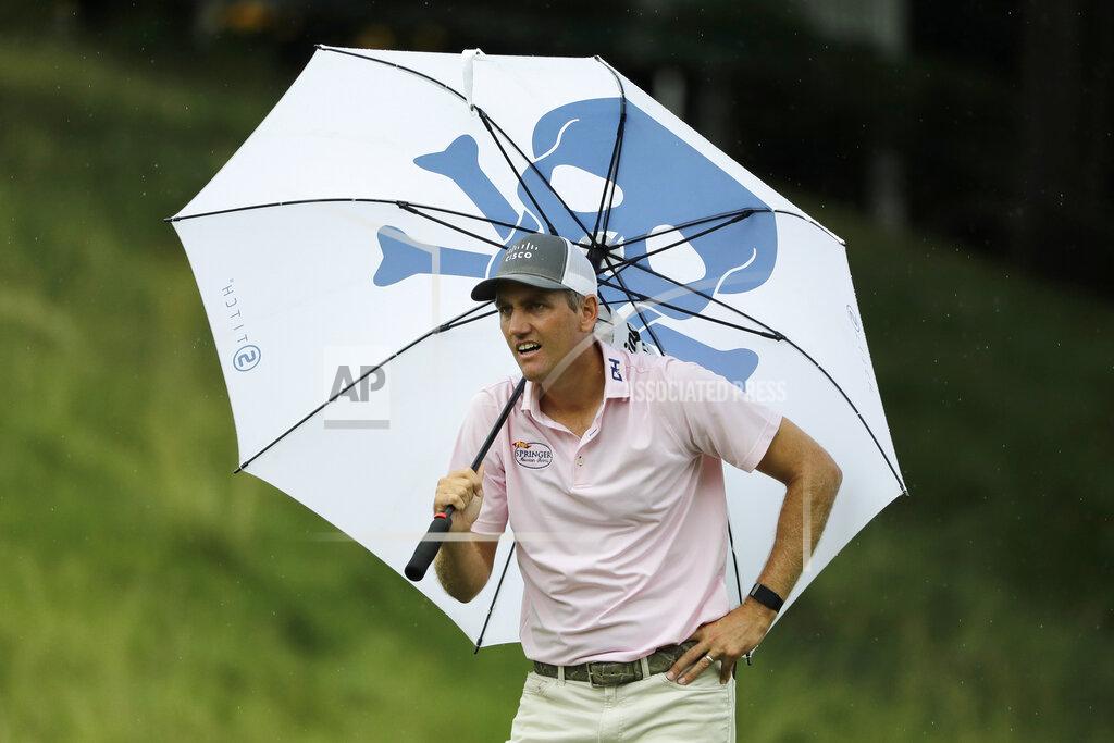 Frank Franklin Ii Brendon Todd looks at a competitors tee shot while sheltering from the rain with an umbrella on the 18th hole during the third round of the Travelers Championship golf tournament at TPC River Highlands, Saturday, June 27, 2020, in Cromwell, Conn. (AP Photo/Frank Franklin II)