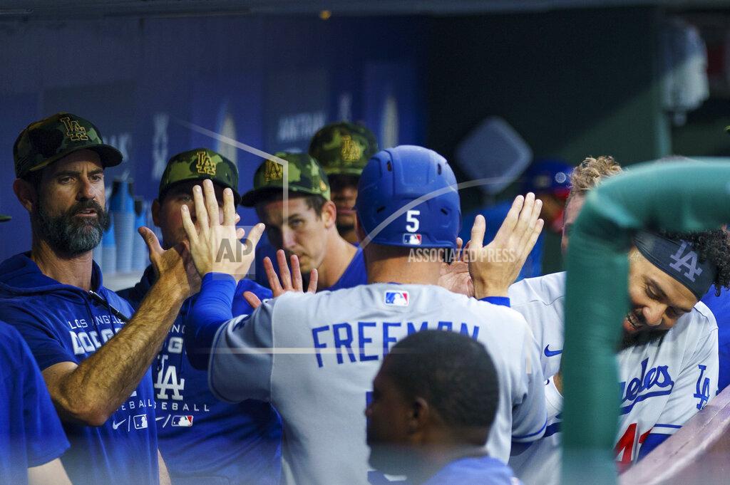 Chris Szagola Los Angeles Dodgers' Freddie Freeman, center, returns to the dugout after scoring against the Philadelphia Phillies during the first inning of a baseball game Friday, May 20, 2022, in Philadelphia. (AP Photo/Chris Szagola)