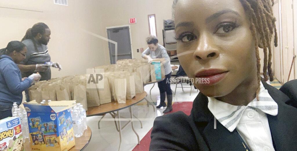 Hattie Norwood This undated photo provided by Hattie Norwood in July 2020 shows her during efforts by the group Proactive Community Involvement to deliver free meals daily to hungry children in Saginaw, Mich. At just 31, she's already witnessing the second major recession of her adult life. Norwood sees Saginaw's problems -- crime, poverty, struggling schools, food deserts -- as entrenched. "Deja vu," she says. (Hattie Norwood via AP)