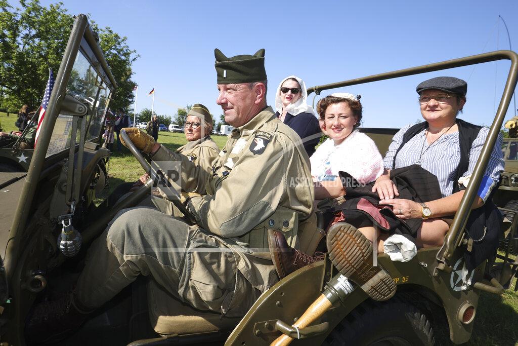 David Vincent World War II history enthusiasts parade in WWII vehicles in Colleville-Montgomery,, Normandy, Saturday June, 5 2021 on the eve of 77th anniversary of the assault that helped bring an end to World War II. While France is planning to open up to vaccinated visitors starting next week, that comes too late for the D-Day anniversary. So for the second year in a row, most public commemoration events have been cancelled. A few solemn ceremonies have been maintained, in the presence of dignitaries and a few guests only. (AP Photo/David Vincent)