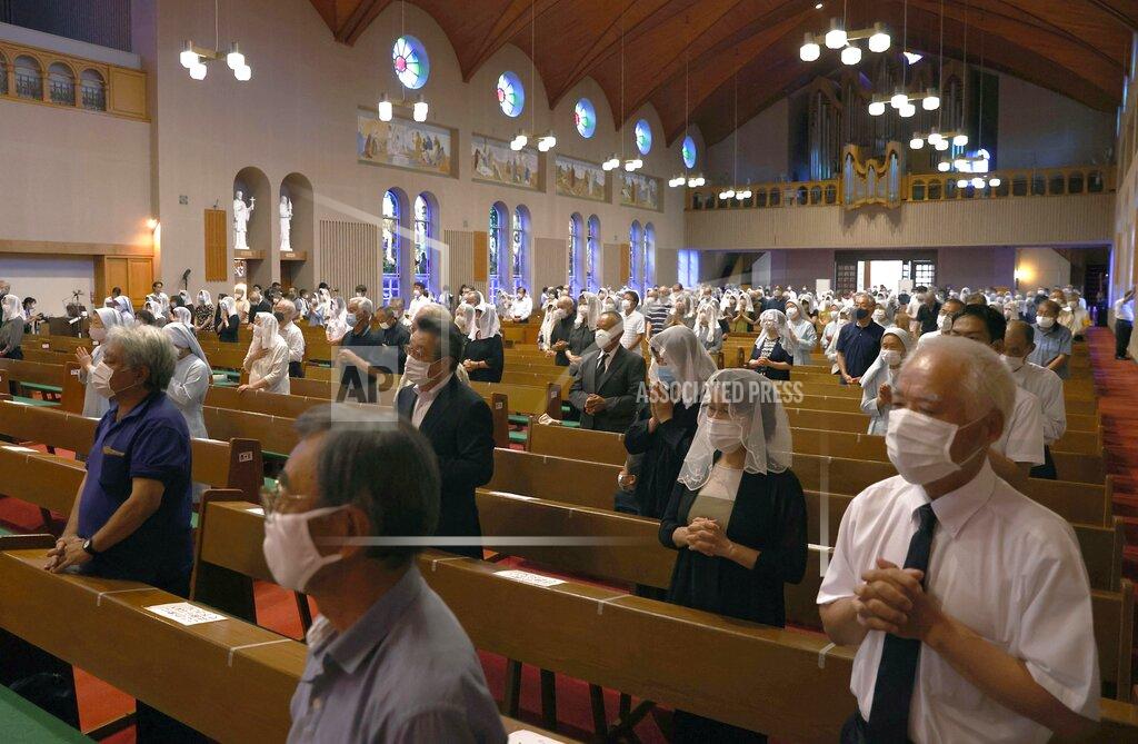 Takuto Kaneko Christians, wearing face masks, pray for the victims of U.S. atomic bombing during a mass at Urakami Cathedral in Nagasaki, southern Japan, Sunday, Aug. 9, 2020. Nagasaki marked the 75th anniversary of the atomic bombing on Sunday. (Takuto Kaneko/Kyodo News via AP)