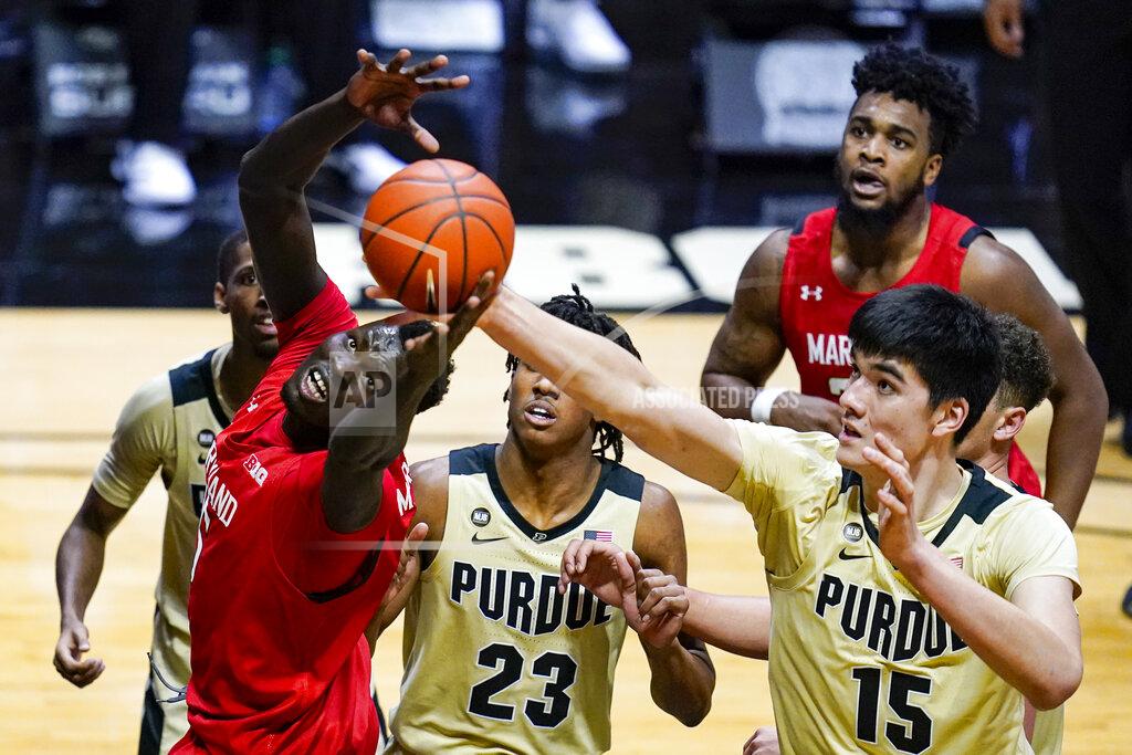 Michael Conroy Maryland guard Eric Ayala (5) tries to pull in a rebound in front of Purdue center Zach Edey (15) during the first half of an NCAA college basketball game in West Lafayette, Ind., Friday, Dec. 25, 2020. (AP Photo/Michael Conroy)