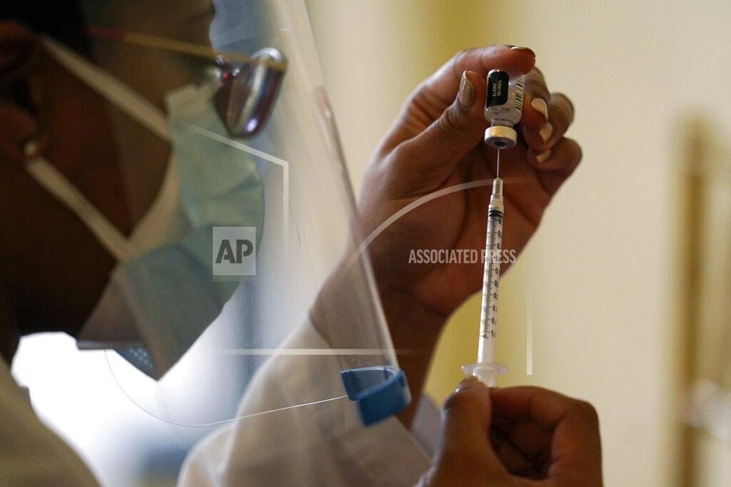 FILE - In this Tuesday, Jan. 12, 2021, file photo, a Walgreens pharmacist prepares a syringe with the Pfizer-BioNTech COVID-19 vaccine for residents and staff at the The Palace assisted living facility in Coral Gables, Fla. Scientists are reporting troubling signs that some recent mutations of the virus that causes COVID-19 may modestly curb the effectiveness of current vaccines but stress that the shots still remain protective. (AP Photo/Lynne Sladky, File)