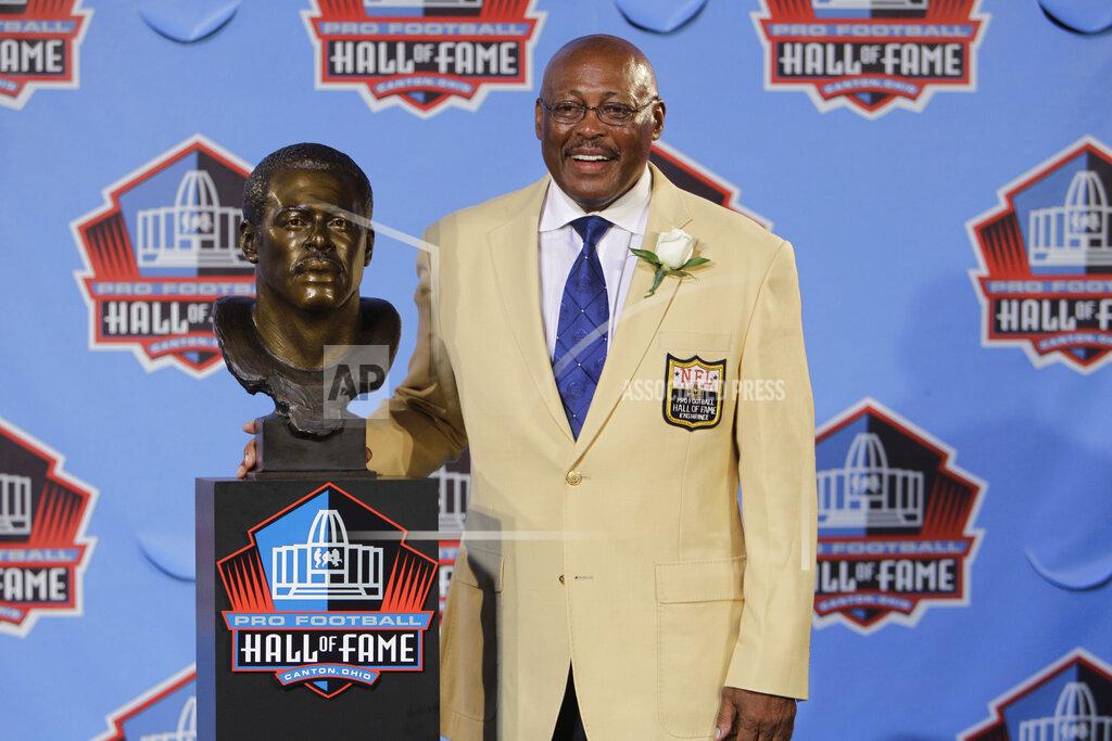 Mark Duncan FILE - In this Aug. 7, 2010 file photo, Floyd Little poses with his bust after enshrinement in the Pro Football Hall of Fame in Canton, Ohio. Little, the Hall of Fame running back who starred at Syracuse and for the Denver Broncos, has died. The Pro Football Hall of Fame said he died Friday, Jan. 1, 2021. (AP Photo/Mark Duncan, File)