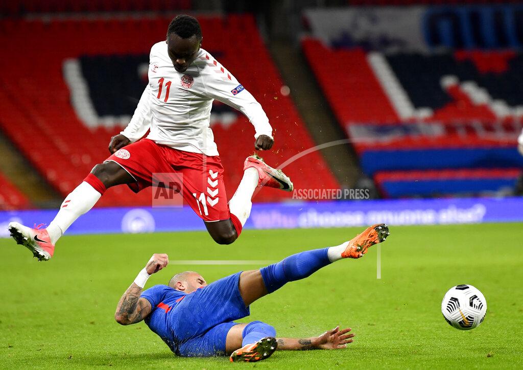 Toby Melville Denmark's Pione Sisto leaps above England's Kyle Walker during the UEFA Nations League soccer match between England and Denmark at Wembley Stadium in London, England, Wednesday, Oct. 14, 2020. (Toby Melville/Pool via AP)