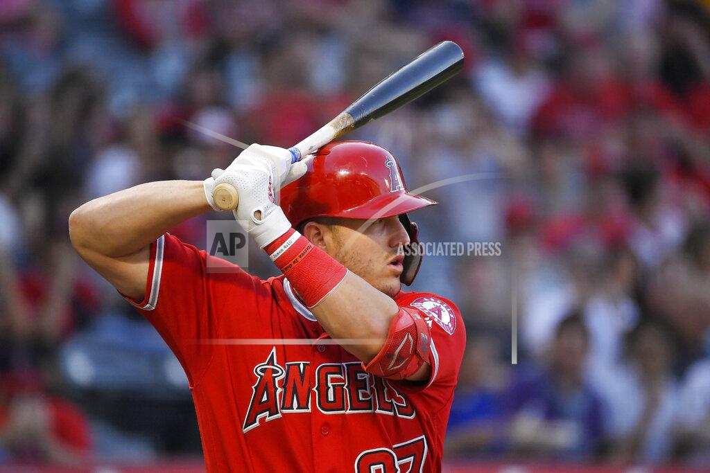 FILE - In this July 25, 2019, file photo, Los Angeles Angels' Mike Trout bats during the first inning of the team's baseball game against the Baltimore Orioles in Anaheim, Calif. Sixty-five players would earn at least $100,000 each time their team wins or loses if the pandemic-delayed major league season get under way, according to an analysis of their contracts by The Associated Press. Trout's salary works out to $222,222 for each game of the 162-game season. (AP Photo/Mark J. Terrill, File)