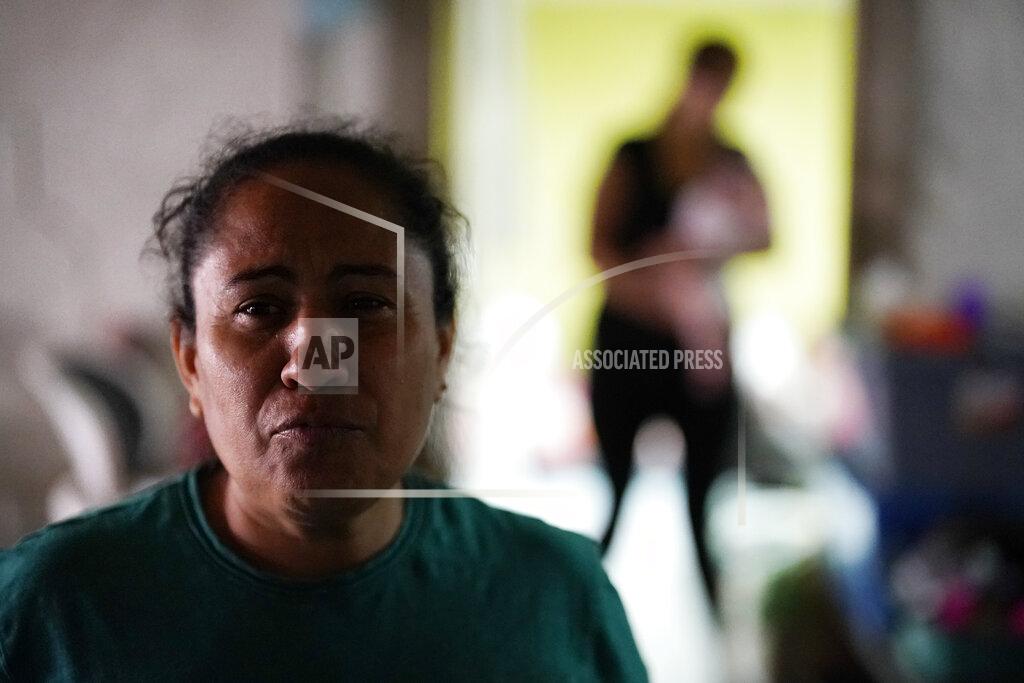 Gregory Bull Iracema Figueroa, left, of Honduras, looks on at a shelter for migrants Friday, May 20, 2022, in Tijuana, Mexico. Figueroa has spent two years trying to reach a safe place for her family and was praying the judge would lift the order. Figueroa left Honduras in 2019 after gangs killed her uncle and threatened her three sons. (AP Photo/Gregory Bull)