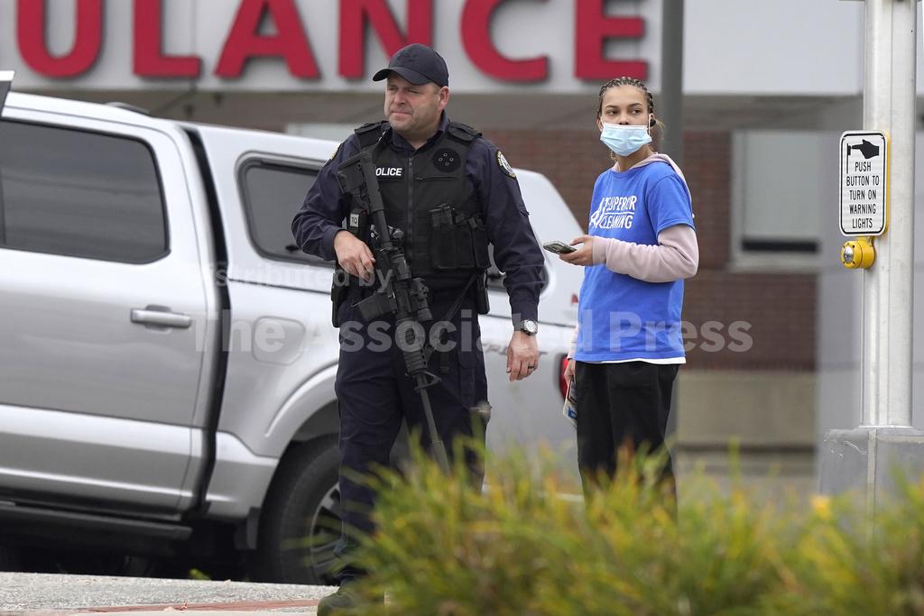 Heavily armed police surround home in search for suspect in the fatal ...