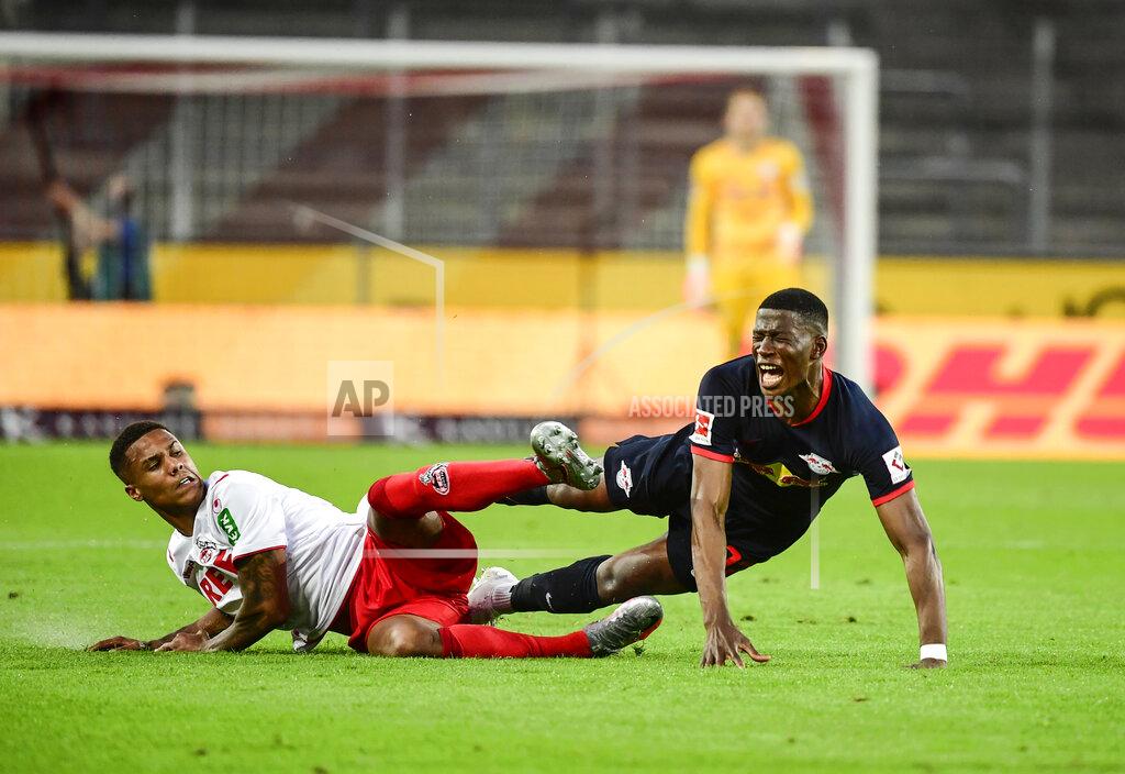 Ina Fassbender Cologne's Spanish defender Jorge Mere, left, and Leipzig's French midfielder Christopher Nkunku battles during the German Bundesliga soccer match between 1. FC Cologne and RB Leipzig, in Cologne, Germany, Monday, June 1, 2020. Because of the coronavirus outbreak all soccer matches of the German Bundesliga take place without spectators. (Ina Fassbender/Pool via AP)