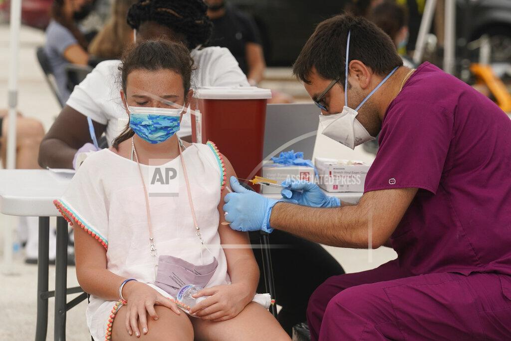 Marta Lavandier FILE - Francesca Anacleto, 12, receives her first Pfizer COVID-19 vaccine shot from nurse Jorge Tase, Wednesday, Aug. 4, 2021, in Miami Beach, Fla. In most states, minors need the consent of their parents in order to be vaccinated against COVID-19. Navigating family politics in cases of differing views has been a challenge for students and organizers of outreach campaigns, who have faced blowback for directly targeting young people. (AP Photo/Marta Lavandier, File)