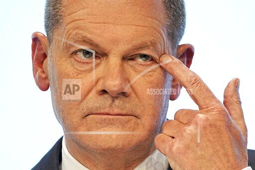 Social Democratic Party, SPD, chancellor candidate Olaf Scholz speaks at a joint news conference in Berlin, Germany, Wednesday, Nov. 24, 2021. After weeks of negotiations the leaders of three parties present a coalition contract for a new German government. (Michael Kappeler/dpa via AP)