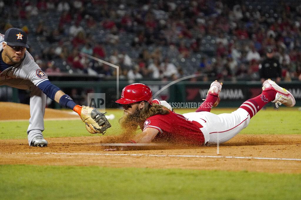 Mark J. Terrill Los Angeles Angels' Brandon Marsh, right, is tagged out at first by Houston Astros first baseman Yuli Gurriel after being caught off base during the sixth inning of a baseball game Wednesday, Sept. 22, 2021, in Anaheim, Calif. (AP Photo/Mark J. Terrill)