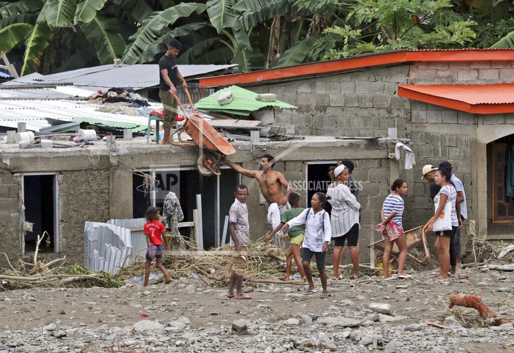 Kandhi Barnez Residents clear up debris from around their houses following a flood in Dili, East Timor, Monday, April 5, 2021. Multiple disasters caused by torrential rains in eastern Indonesia and neighboring East Timor have left a number of people dead or missing as rescuers were hampered by damaged bridges and roads and a lack of heavy equipment Monday. (AP Photo/Kandhi Barnez)