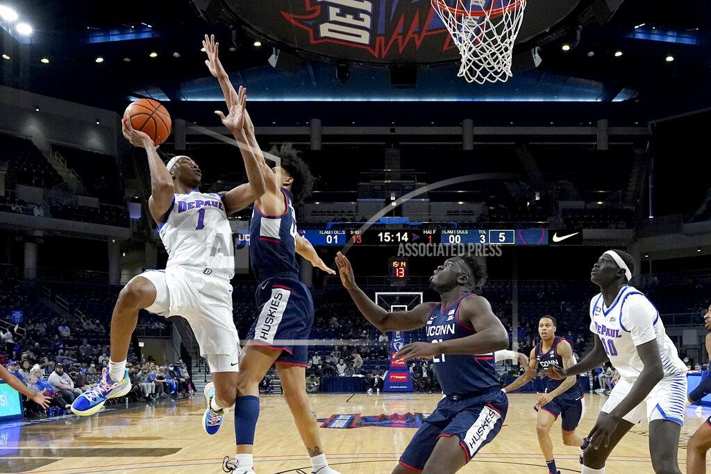 Charles Rex Arbogast DePaul's Javan Johnson (1) shoots under pressure from Connecticut's Andre Jackson during the first half of an NCAA college basketball game Saturday, Jan. 29, 2022, in Chicago. (AP Photo/Charles Rex Arbogast)