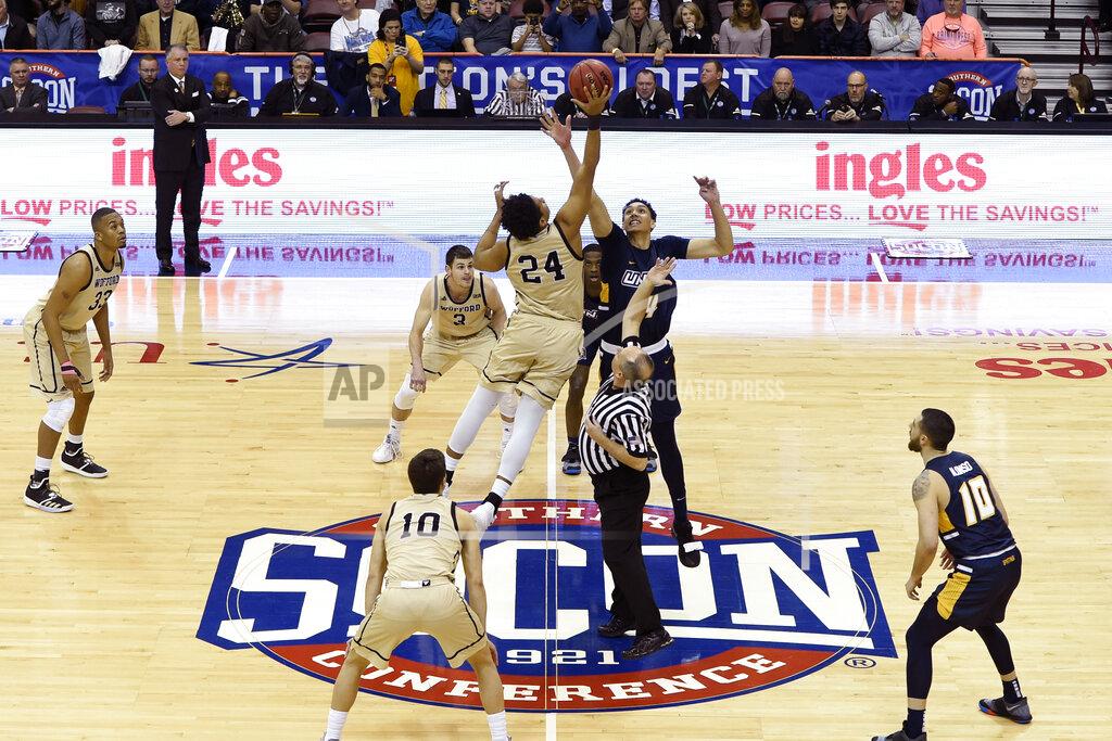Kathy Kmonicek Wofford forward Keve Aluma (24) and UNC-Greensboro forward Kyrin Galloway (14) tip off for the start of an NCAA college basketball game for the Southern Conference tournament championship, Monday, March 11, 2019, in Asheville, N.C. (AP Photo/Kathy Kmonicek)