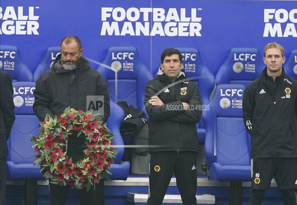 Tim Keeton Wolverhampton Wanderers manager Nuno Espirito Santo holds a wreath during remembrance commemorations before the English Premier League soccer match between Leicester City and Wolverhampton Wanderers at King Power Stadium in Leicester, England, Sunday, Nov. 8, 2020. (Tim Keeton/Pool via AP)