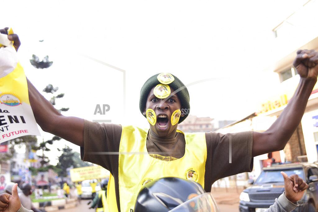 Nicholas Bamulanzeki A supporter of Ugandan President Yoweri Kaguta Museveni celebrates, in Kampala, Uganda, Saturday Jan. 16, 2021, after their candidate was declared winner of the presidential elections. Uganda’s electoral commission says longtime President Yoweri Museveni has won a sixth term, while top opposition challenger Bobi Wine alleges rigging and officials struggle to explain how polling results were compiled amid an internet blackout. In a generational clash widely watched across the African continent, the young singer-turned-lawmaker Wine posed arguably the greatest challenge yet to Museveni. (AP Photo/Nicholas Bamulanzeki)