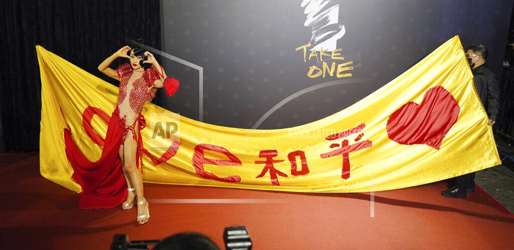 Billy Dai Chinese-American actress Bai Ling poses with her slogan "Love, Peace" at the 57th Golden Horse Awards in Taipei, Taiwan, Saturday, Nov. 21, 2020. Bai is nominated for Best Leading Actress for the film "The Abortionist" at this year's Golden Horse Awards -one of the Chinese-language film industry's biggest annual events. (AP Photo/Billy Dai)