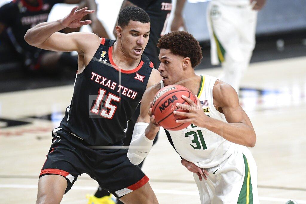 Justin Rex Baylor's MaCio Teague (31) drive the ball against Texas Tech's Kevin McCuller (15) during the first half of an NCAA college basketball game in Lubbock, Texas, Saturday, Jan. 16, 2021. (AP Photo/Justin Rex)
