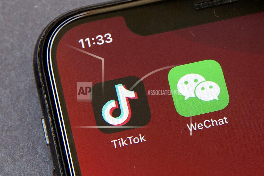 FILE - Icons for the smartphone apps TikTok and WeChat are seen on a smartphone screen in Beijing, in a Friday, Aug. 7, 2020 file photo. Some U.S.-based users of WeChat are suing President Donald Trump in a bid to block an executive order that they say would effectively prohibit U.S. access to the popular Chinese messaging app. The complaint was filed Friday, Aug. 21, 2020 in San Francisco and asks a federal court judge to stop Trump’s order from being enforced. It claims a ban would violate U.S. users’ constitutional rights. (AP Photo/Mark Schiefelbein, File)