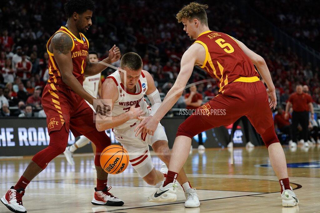 Morry Gash Wisconsin's Brad Davison loses the ball as he drives between Iowa State's Izaiah Brockington and Aljaz Kunc during the second half of a second-round NCAA college basketball tournament game Sunday, March 20, 2022, in Milwaukee. (AP Photo/Morry Gash)