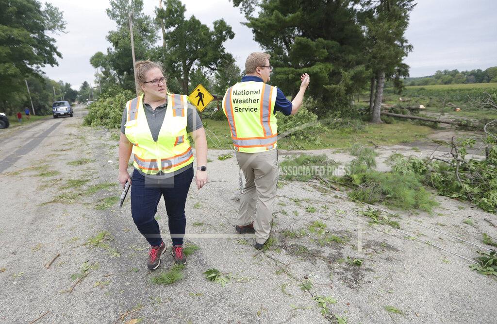 Mike De Sisti National Weather Service meteorologists Jaclyn Anderson, left and Kevin Wagner survey the damage to determine if there was a tornado in the Town of Concord, Wis., on Thursday, July 29, 2021. A line of thunderstorms arrived early Thursday generating numerous tornado warnings as well as high winds and near-constant lightning. (Mike De Sisti/Milwaukee Journal-Sentinel via AP)