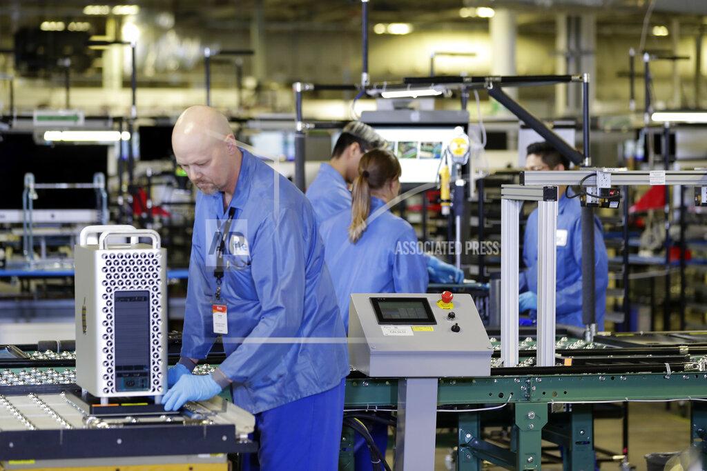 FILE - In this Nov. 20, 2019, file photo workers assemble Apple products at an Apple manufacturing plant in Austin, Texas. As state and federal leaders tussle over when and how fast to “reopen” the U.S. economy amid the coronavirus pandemic, some corporations are taking the first steps toward bringing their employees back to work. (AP Photo/ Evan Vucci, File)