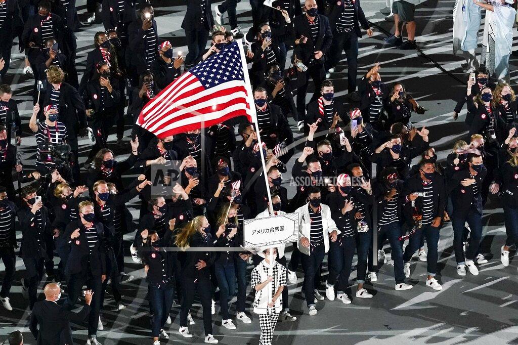 Morry Gash Sue Bird and Eddy Alvares, of the United States of America, carry their country's flag during the opening ceremony at the Olympic Stadium at the 2020 Summer Olympics, Friday, July 23, 2021, in Tokyo. (AP Photo/Morry Gash)