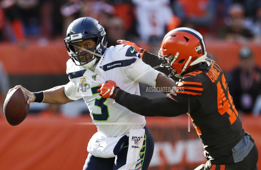 Ron Schwane Seattle Seahawks quarterback Russell Wilson (3) avoids Cleveland Browns strong safety Morgan Burnett (42) during the second half of an NFL football game, Sunday, Oct. 13, 2019, in Cleveland. (AP Photo/Ron Schwane)