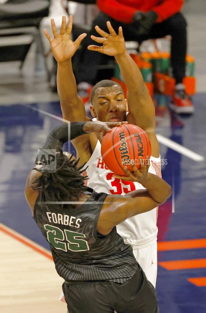 Ron Jenkins Tulane guard Jaylen Forbes (25) goes up to shoot as Houston forward Fabian White Jr. (35) defends the basket during the first half of an NCAA college basketball game in the quarterfinal round of the American Athletic Conference men's tournament Friday, March 12, 2021, in Fort Worth, Texas. (AP Photo/Ron Jenkins)