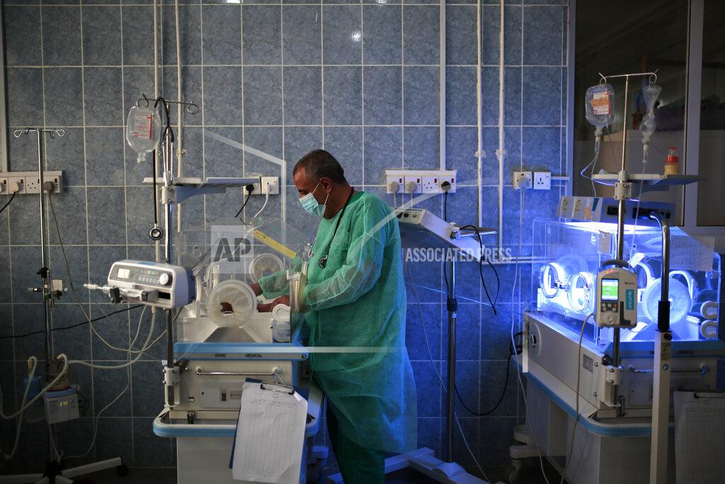 Hani Mohammed FILE - In this Saturday, June 27, 2020 file photo, a doctor checks a malnourished newborn baby inside an incubator at Al-Sabeen hospital in Sanaa, Yemen. Coronavirus restrictions on movement have blocked the distribution of aid, along with the stalling of salaries and price hikes. (AP Photo/Hani Mohammed)