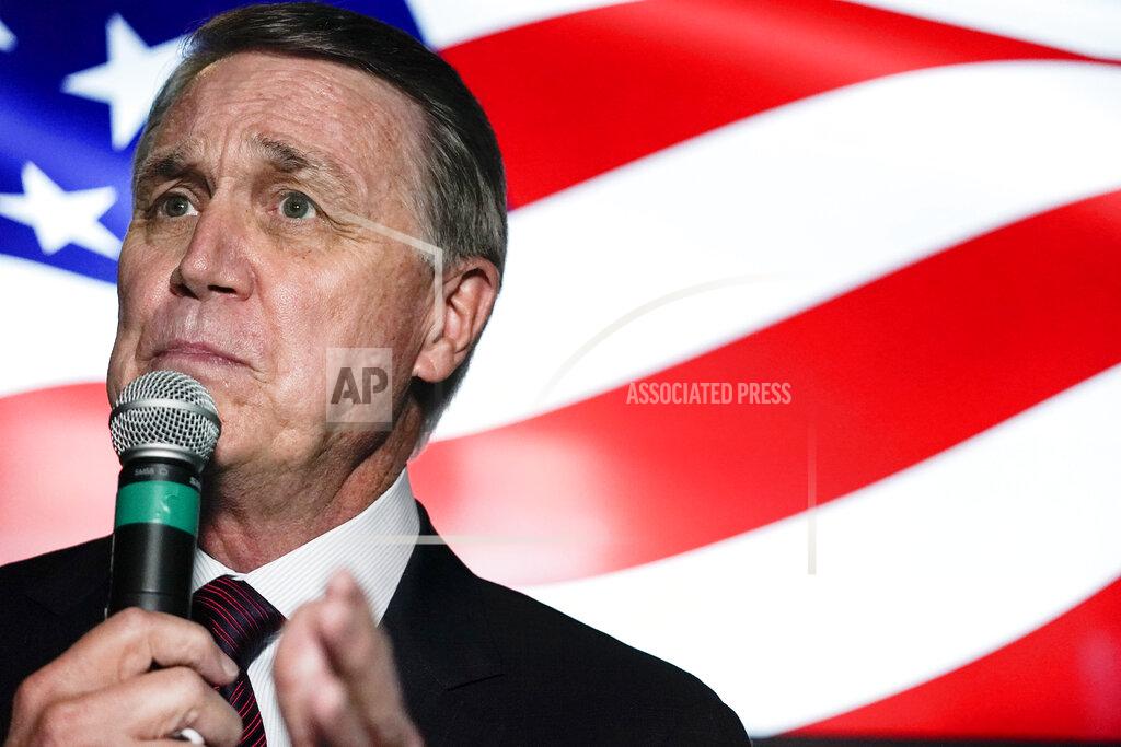 Brynn Anderson Republican candidate for U.S. Senate Sen. David Perdue speaks during a campaign rally on Friday, Nov. 13, 2020, in Cumming, Ga. Perdue and Democratic candidate Jon Ossoff are in a runoff election for the Senate seat in Georgia. (AP Photo/Brynn Anderson)