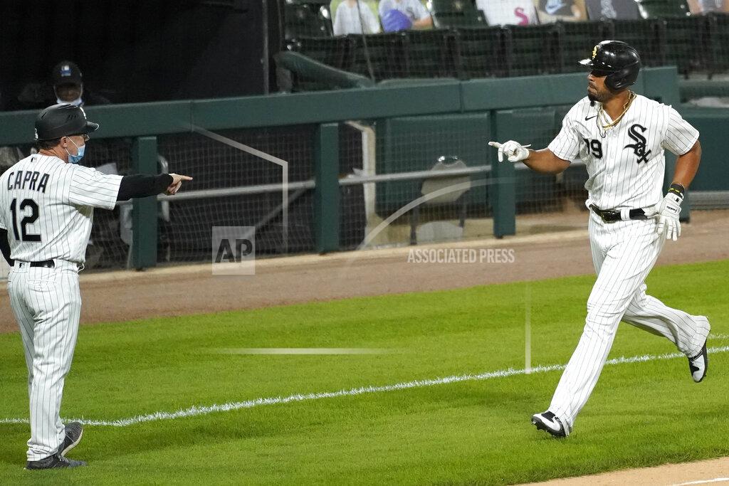 Nam Y. Huh Chicago White Sox's Jose Abreu, right, celebrates with third base coach Nick Capra after hitting a solo home run during the eighth inning of a baseball game against the Detroit Tigers in Chicago, Wednesday, Aug. 19, 2020. (AP Photo/Nam Y. Huh)