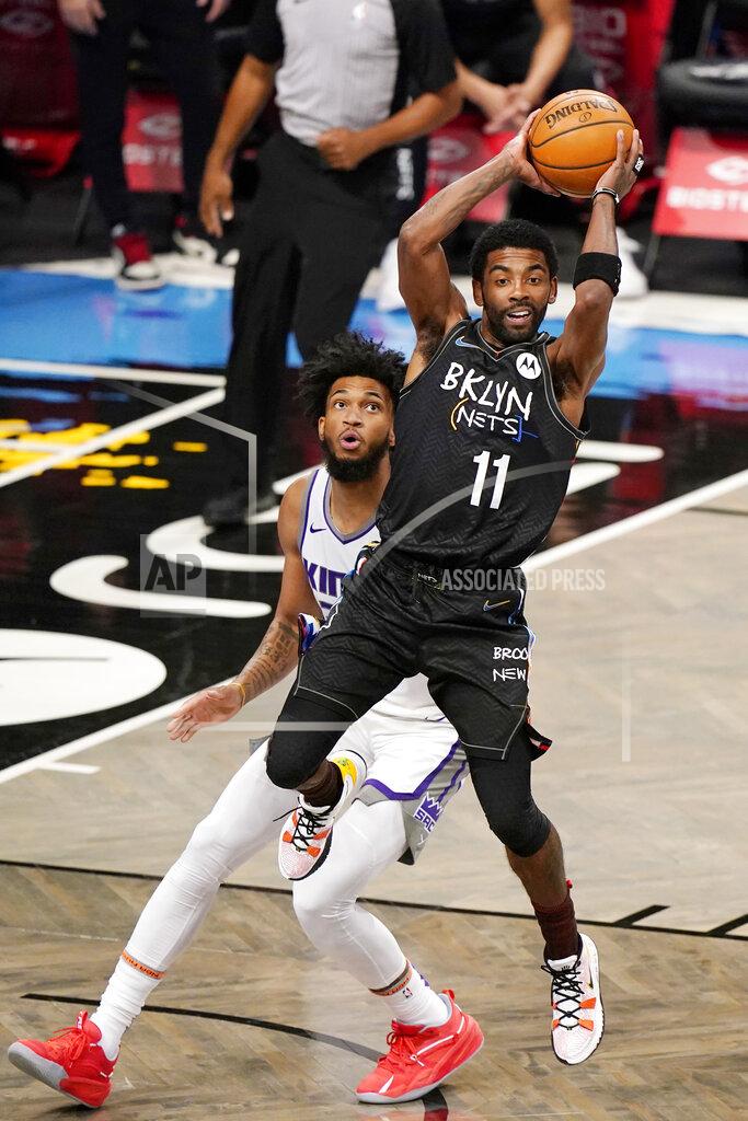 Kathy Willens Sacramento Kings forward Marvin Bagley III, left, looks on as Brooklyn Nets guard Kyrie Irving, right, passes during the first quarter of an NBA basketball game, Tuesday, Feb. 23, 2021, in New York. (AP Photo/Kathy Willens)