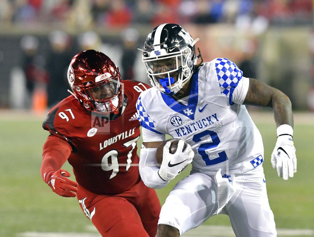 Timothy D. Easley Kentucky wide receiver Dorian Baker (2) runs from Louisville linebacker Nick Okeke (97) during the second half of an NCAA college football game in Louisville, Ky., Saturday, Nov. 24, 2018. (AP Photo/Timothy D. Easley)