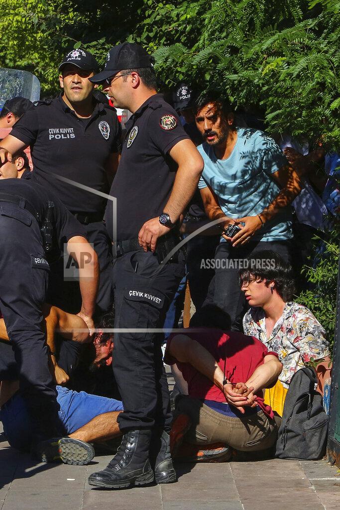Ali Unal People is detained during the LGBTQ Pride March in Ankara, Turkey, Tuesday, July 5, 2022. Police in Turkey’s capital have broken up a LGBTQ Pride march and detained dozens of people. Turkish authorities have banned LGBTQ events. (AP Photo/Ali Unal)