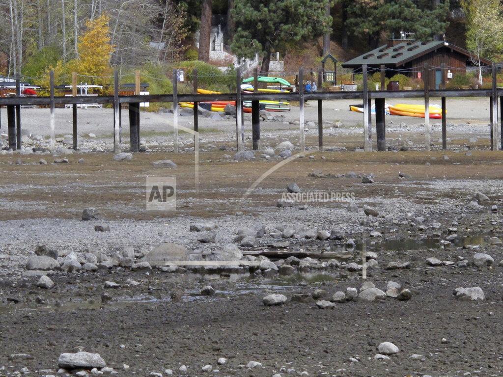 Scott Sonner Kayaks and rafts are stacked along Lake Tahoe's receding shoreline Wednesday, Oct. 20, 2021 at Tahoe City, Calif. Drought fueled by climate change has dropped Lake Tahoe below its natural rim and halted flows into the Truckee River, an historically cyclical event that's occurring sooner and more often than it used to raising fears about what might be in store for the famed alpine lake. (AP Photo/Scott Sonner).