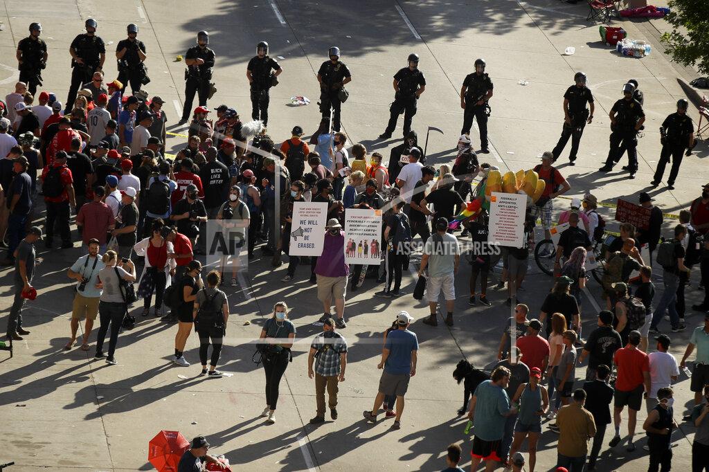 Charlie Riedel Protesters and supporters argue outside the BOK Center where President Trump will hold a campaign rally in Tulsa, Okla., Saturday, June 20, 2020. (AP Photo/Charlie Riedel)