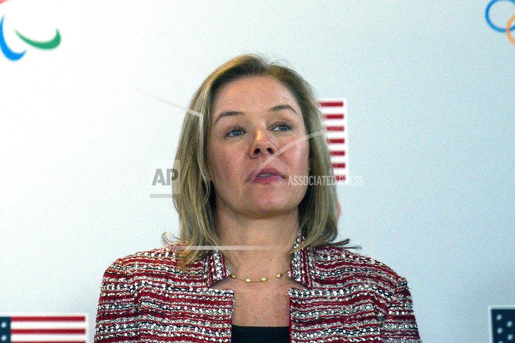 FILE - In this Feb. 18, 2020, file photo, United States Olympic and Paralympic Committee CEO Sarah Hirshland listens as President Donald Trump speaks during a briefing with the U.S. Olympic and Paralympic Committee and Los Angeles 2028 organizers in Beverly Hills, Calif. Even before the coronavirus pandemic wiped the Summer Olympics off the 2020 sports calendar, the U.S. Olympic and Paralympic Committee was an organization in peril. In a first-of-its-kind virtual address, leaders of the committee paid heed to how much more difficult things have become since the virus started shutting down sports, over the last seven months. (AP Photo/Evan Vucci, File)