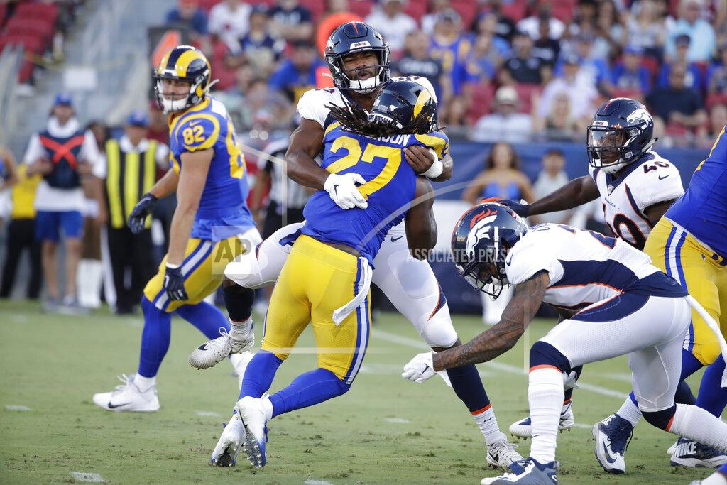 Rick Scuteri Los Angeles Rams running back Darrell Henderson (27) is tackled by Denver Broncos linebacker Justin Hollins during the first half of an NFL preseason football game Saturday, Aug. 24, 2019, in Los Angeles. (AP Photo/Rick Scuteri)