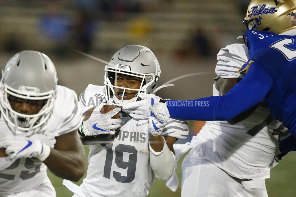 Sue Ogrocki Memphis running back Kenneth Gainwell (19) has his face mask grabbed by a Tulsa defender as he carries in the first half of an NCAA college football game in Tulsa, Okla., Saturday, Oct. 26, 2019. (AP Photo/Sue Ogrocki)