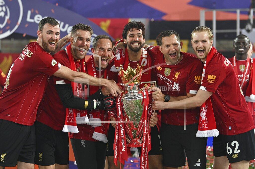 Paul Ellis Liverpool's goalkeeper Alisson, center, celebrates with teammates following the English Premier League soccer match between Liverpool and Chelsea at Anfield Stadium in Liverpool, England, Wednesday, July 22, 2020. Liverpool are champions of the EPL for the season 2019-2020. The trophy is presented at the teams last home game of the season. Liverpool won the match against Chelsea 5-3. (Paul Ellis, Pool via AP)