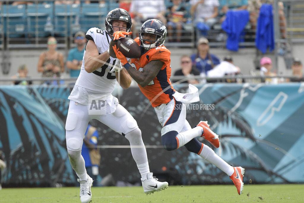 Phelan M. Ebenhack Denver Broncos safety Kareem Jackson, right, intercepts a pass in front of Jacksonville Jaguars tight end Luke Farrell during the second half of an NFL football game, Sunday, Sept. 19, 2021, in Jacksonville, Fla. (AP Photo/Phelan M. Ebenhack)