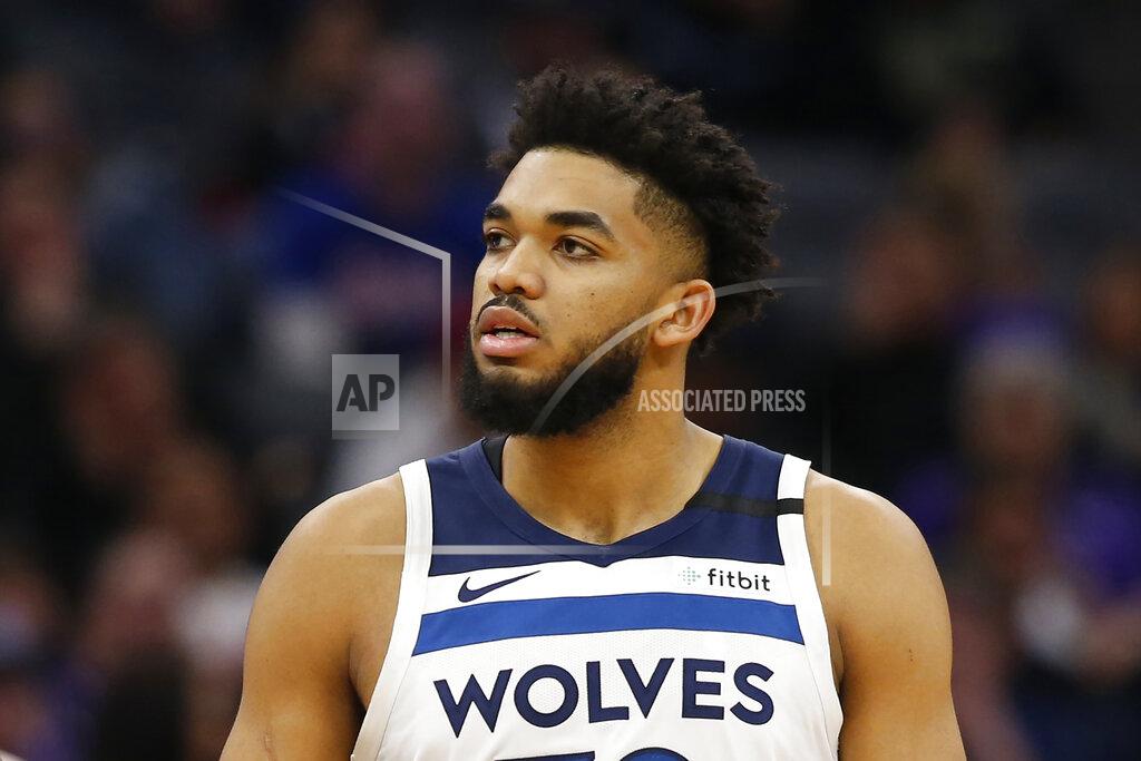 Rich Pedroncelli FILE - In this Feb. 3, 2020, file photo, Minnesota Timberwolves center Karl-Anthony Towns is shown during the second half of an NBA basketball game against the Sacramento Kings in Sacramento, Calif. Towns says his mother is hospitalized and in a medically-induced coma after contracting the new coronavirus. Towns talked about his mother's condition Wednesday, March 25, 2020, on his Instagram page and urged his followers to take COVID-19 seriously and practice social distancing. (AP Photo/Rich Pedroncelli, File)
