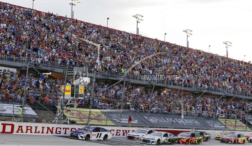Terry Renna FLE - In this Sept. 2, 2018, file photo, Denny Hamlin (11) leads the pack to start the NASCAR Cup Series auto race at Darlington Raceway in Darlington, S.C. NASCAR will get its season back on track starting May 17 at Darlington Raceway in South Carolina without spectators, and the premier Cup Series plans to race four times in 10 days at a pair of iconic tracks. The revised schedule released Thursday, April 30, 2020, goes only through May and has a pair of Wednesday races — fulfilling fans longtime plea for midweek events. (AP Photo/Terry Renna, File)