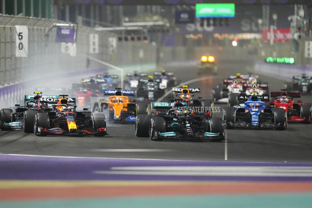 Hassan Ammar Mercedes driver Lewis Hamilton of Britain leads at the restart of the Formula One Saudi Arabian Grand Prix in Jiddah, Sunday, Dec. 5, 2021. (AP Photo/Hassan Ammar)