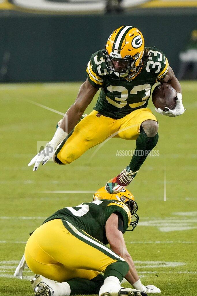Morry Gash Green Bay Packers' Aaron Jones leaps over teammate Robert Tonyan during the second half of an NFL football game against the Philadelphia Eagles Sunday, Dec. 6, 2020, in Green Bay, Wis. (AP Photo/Morry Gash)